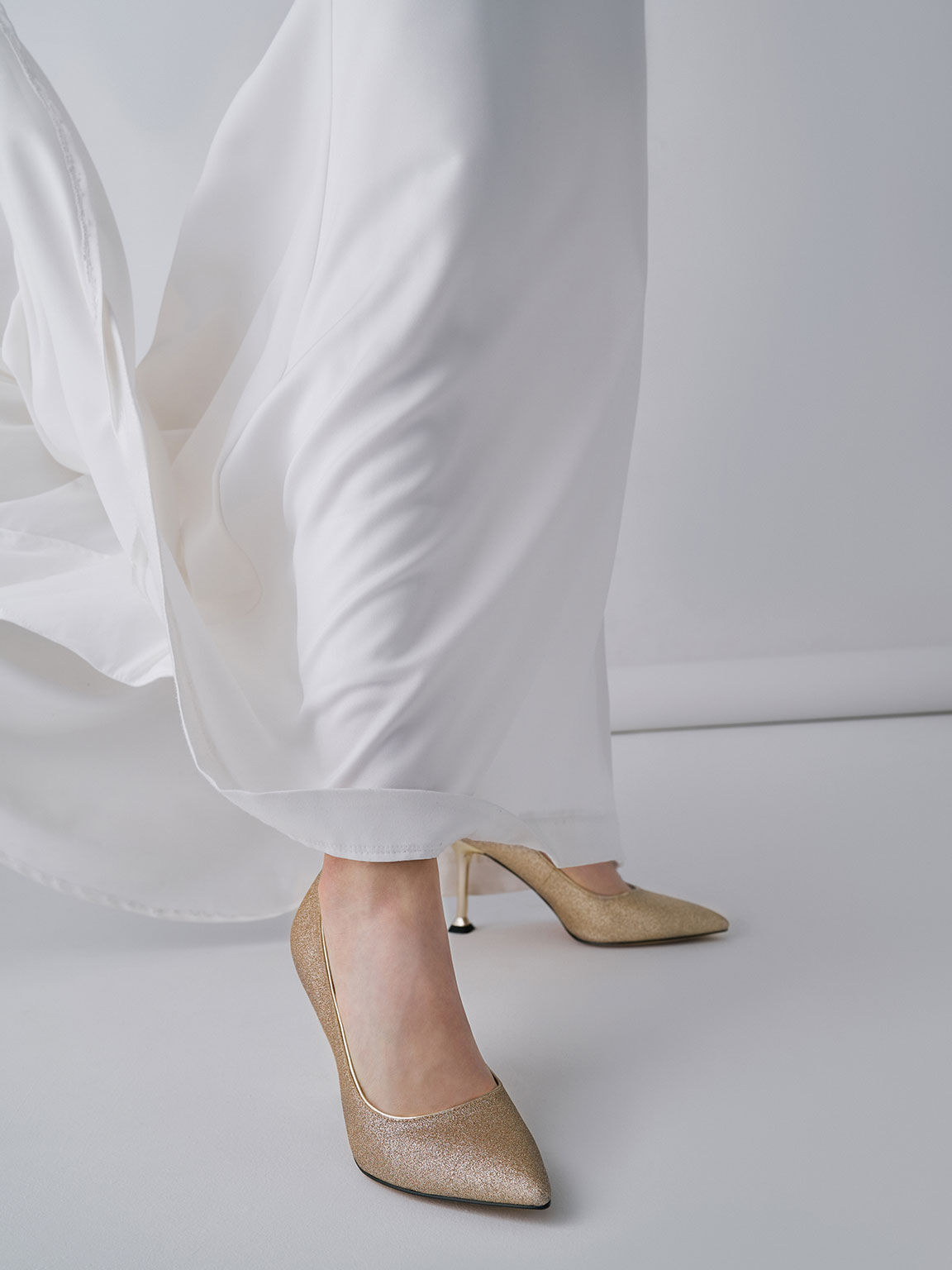 White pumps with 2025 gold heel