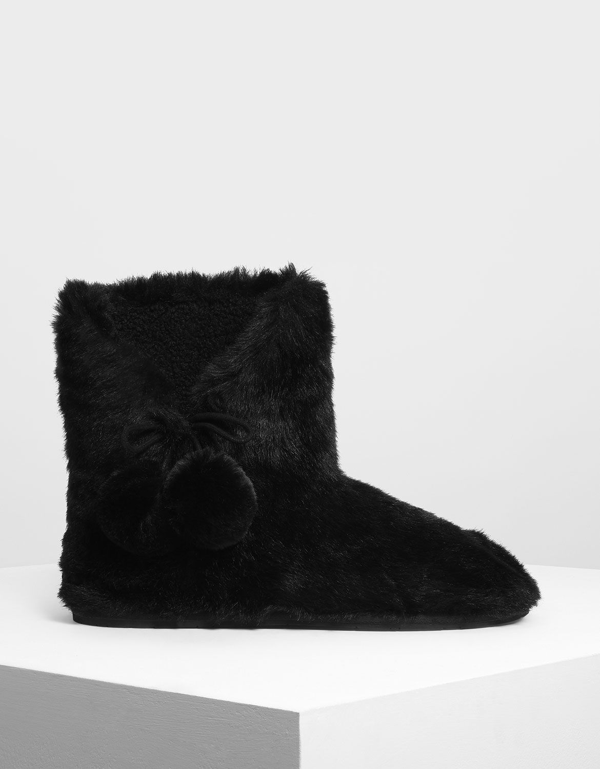 furry boots with pom poms