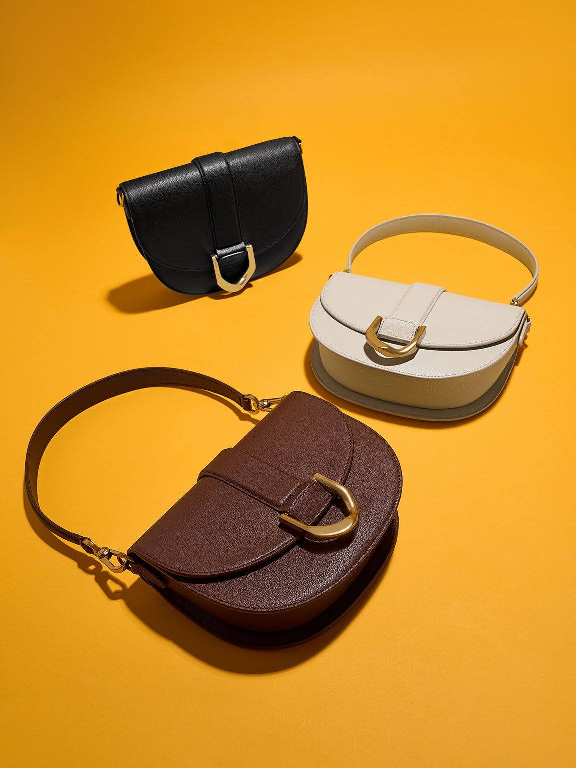 Charles_Keith on X: The Gabine leather saddle bag and buckled