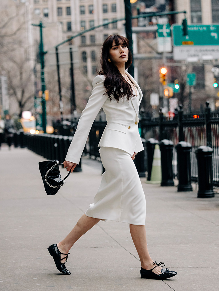 Women’s Andromeda chunky-chain top handle bag in noir and crinkle-effect lace-up bow ballet flats in black, as seen on Natalie Lim Suarez – CHARLES & KEITH