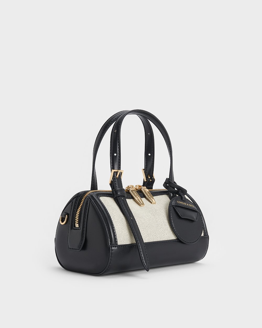 Women’s Enola Canvas Bowling Bag in black and Enola Canvas Bowling Bag in cream - CHARLES & KEITH