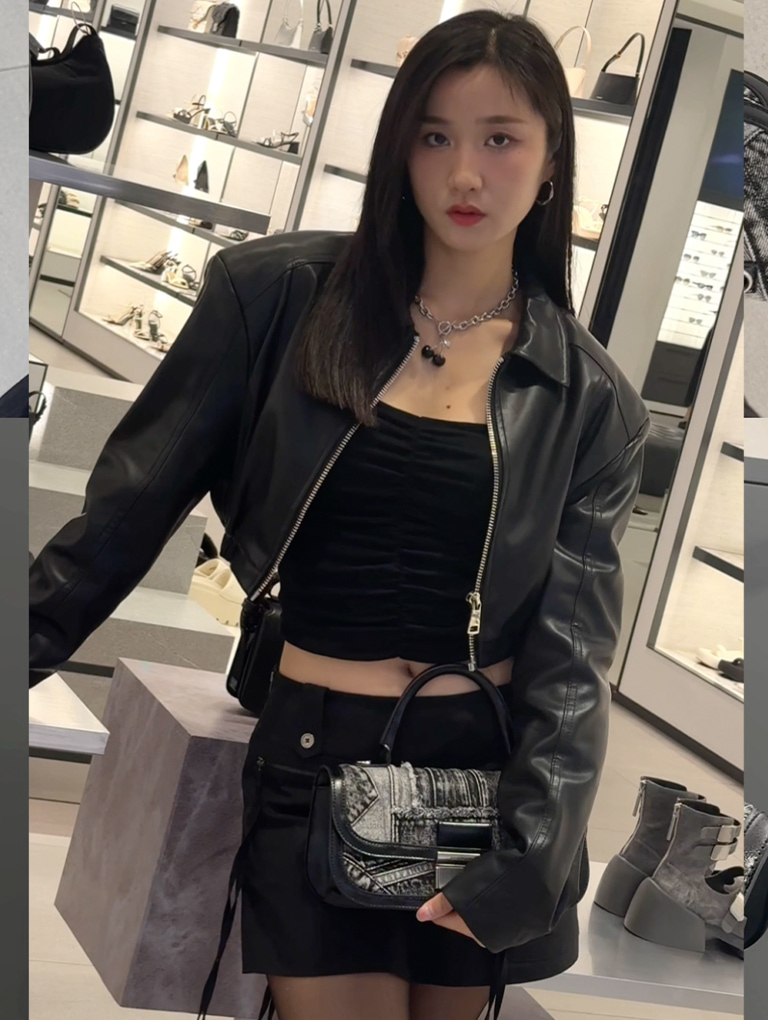 Nihyun completes her cool biker-girl outfit with the Charlot patchwork denim elongated top handle bag in noir — CHARLES & KEITH