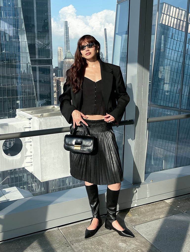 Women’s Charlot elongated top handle bag in black & Robbie cut-out pointed-toe knee-high boots in black, as seen on Natalie Lim Suarez - CHARLES & KEITH