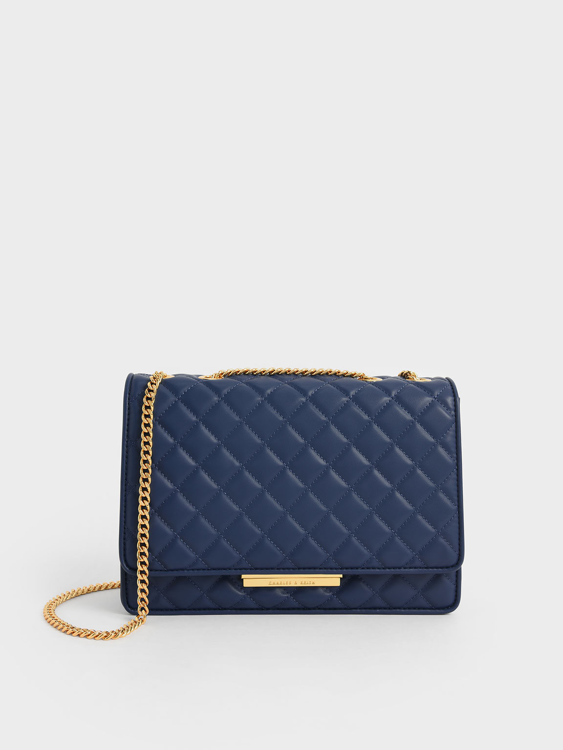 Quilted satin clutch bag with shoulder strap